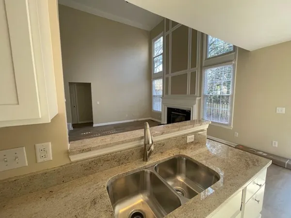 a kitchen with a sink and large window