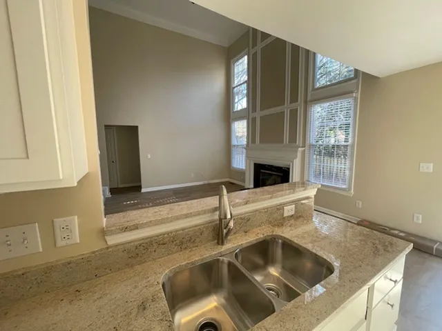 a kitchen with a sink and large window