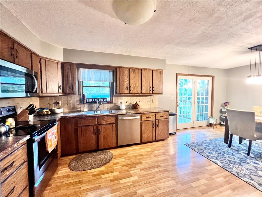 847 Patton Road New Castle, PA 16105 - Photo 8 of 25 a kitchen with stainless steel appliances granite countertop a stove a sink dishwasher and a microwave oven with cabinets