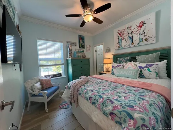 a bedroom with a bed and a chandelier