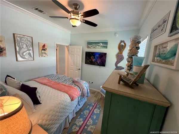 a bedroom with a bed and a chandelier