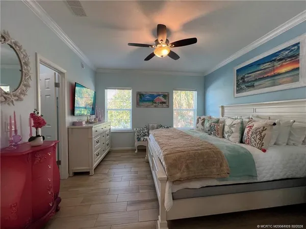 a bedroom with a bed and a chandelier