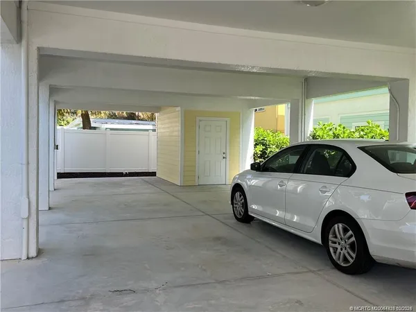 a view of a chairs and table in patio with a yard