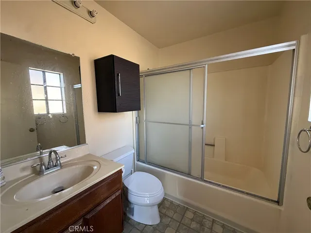 a kitchen with stainless steel appliances a sink stove and cabinets
