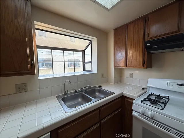 a large kitchen with a stove and refrigerator