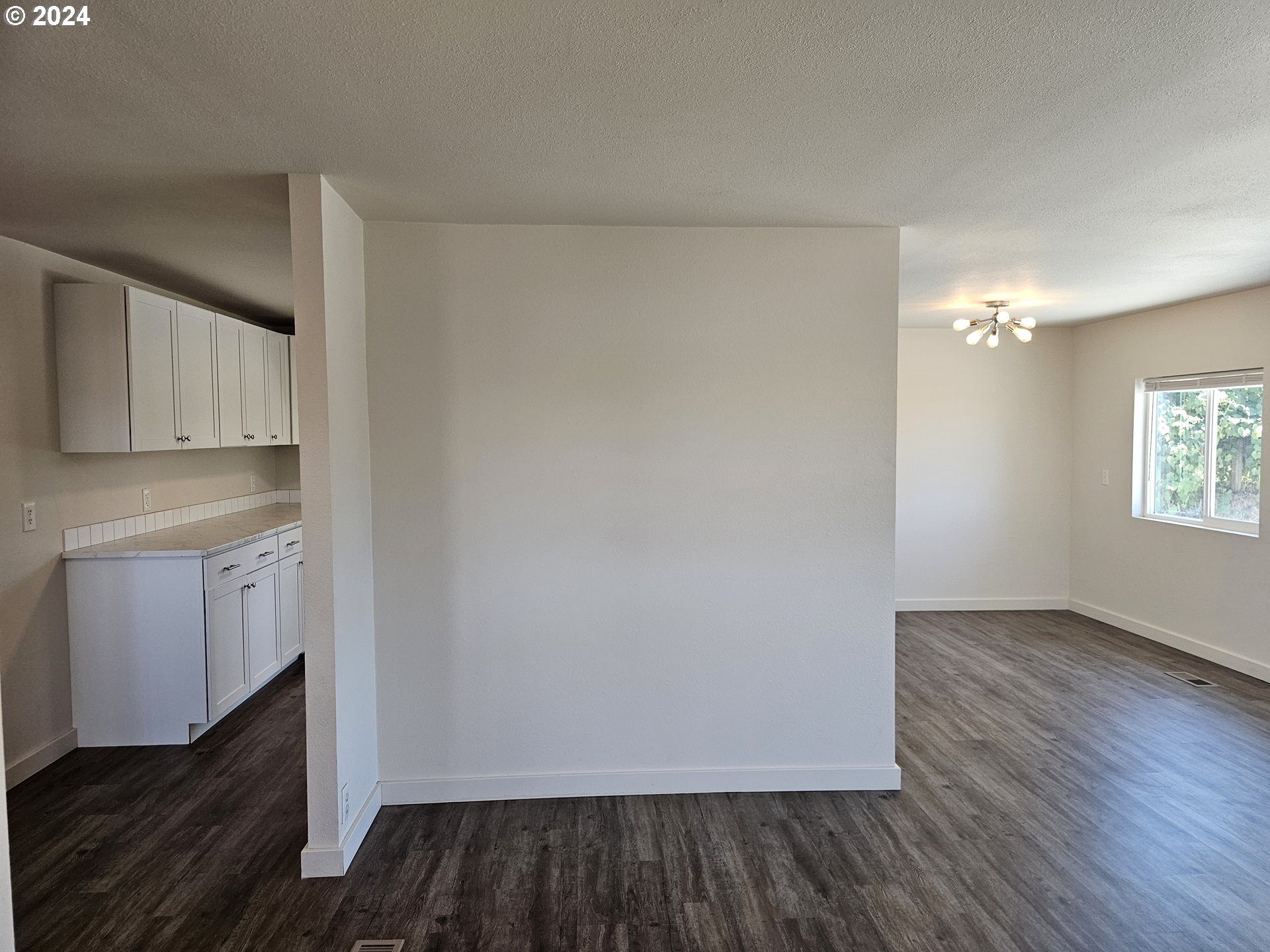 806 Southwest 10th Street Pendleton, OR 97801 - Photo 11 of 36 a view of an empty room with wooden floor and a window