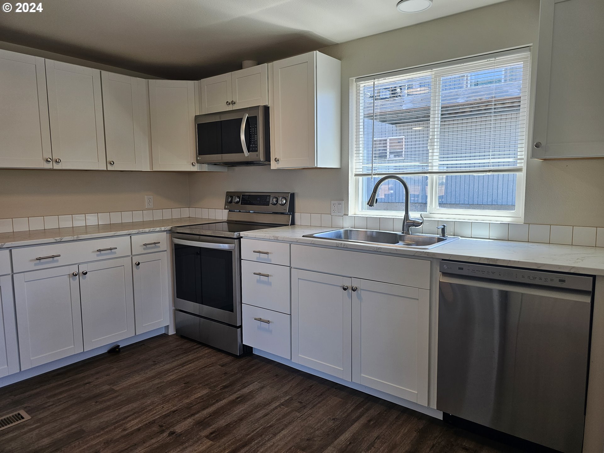 806 Southwest 10th Street Pendleton, OR 97801 - Photo 16 of 36 a kitchen with white cabinets stainless steel appliances and sink