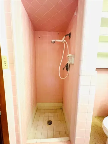 a white toilet sitting next to a bathroom sink and vanity