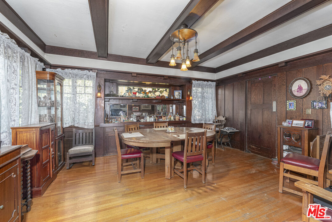 1432 Valley View Road Glendale, CA 91202 - Photo 6 of 17 a dining area with furniture a rug and a chandelier