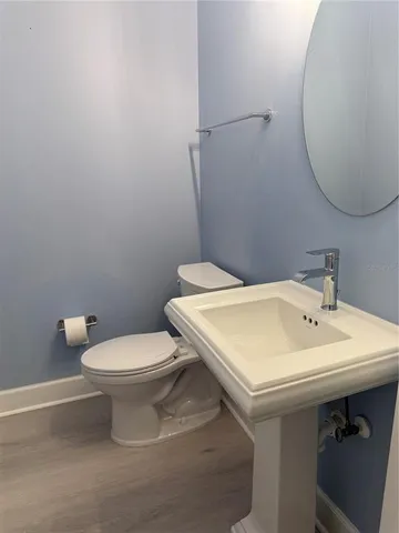 a white toilet sitting next to a bathroom sink