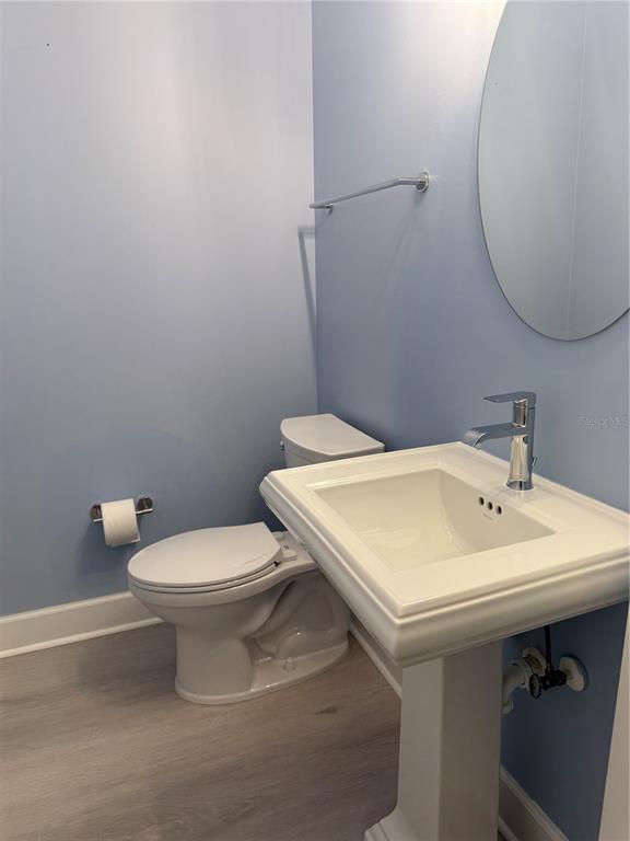 116 131st Avenue East, Unit C Madeira Beach, FL 33708 - Photo 12 of 41 a white toilet sitting next to a bathroom sink