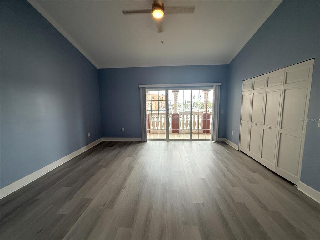 116 131st Avenue East, Unit C Madeira Beach, FL 33708 - Photo 14 of 41 an empty room with wooden floor and windows