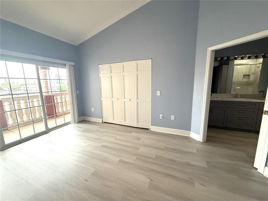 116 131st Avenue East, Unit C Madeira Beach, FL 33708 - Photo 15 of 41 a view of an empty room with a window and wooden floor