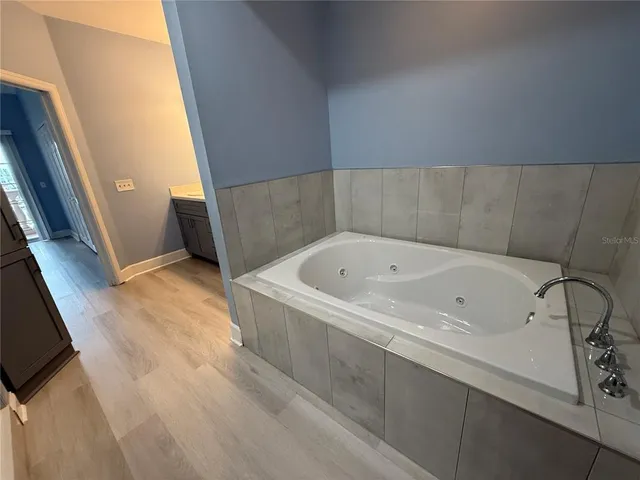 a bathroom with a bathtub and shower