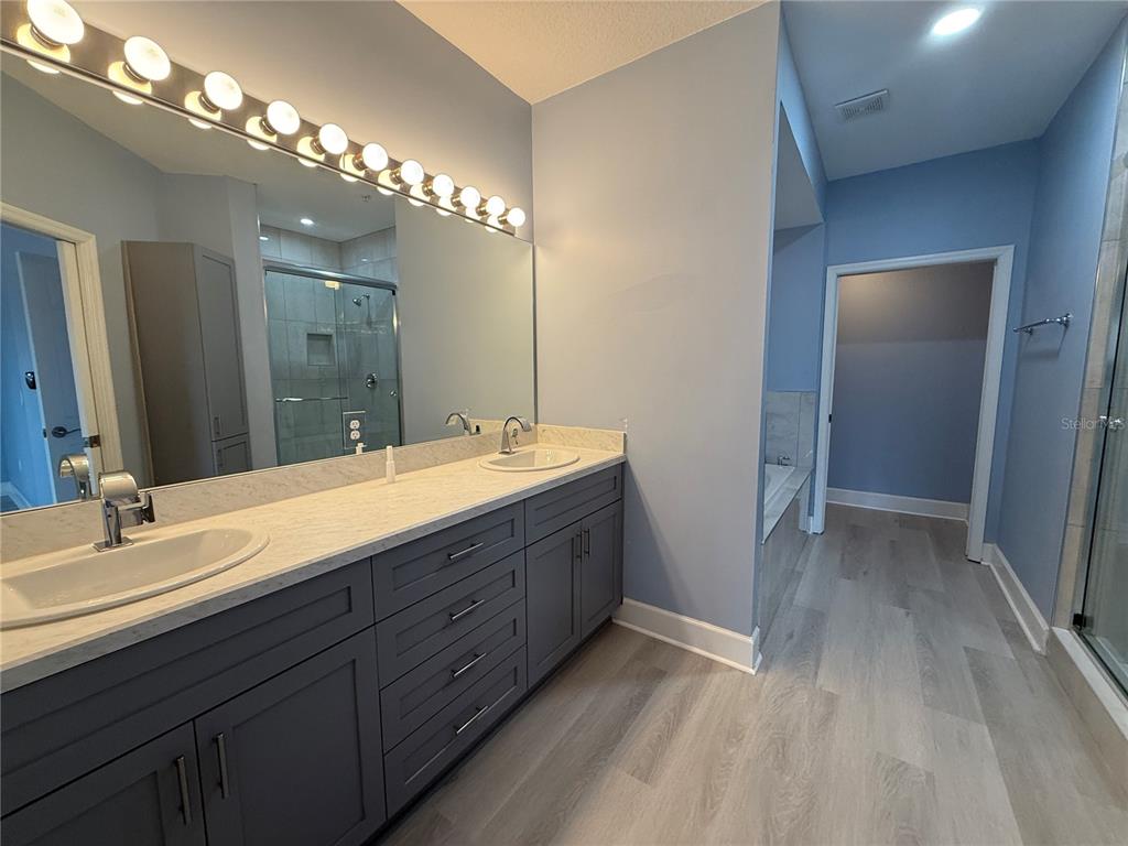 116 131st Avenue East, Unit C Madeira Beach, FL 33708 - Photo 17 of 41 a bathroom with double vanity sink a vanity and a mirror