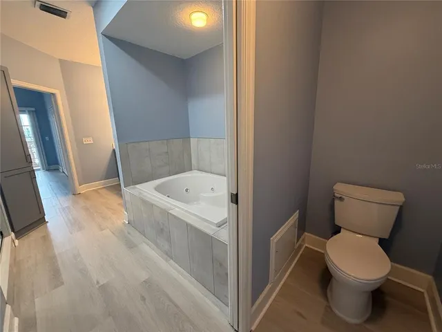 a white toilet sitting next to a bathroom sink
