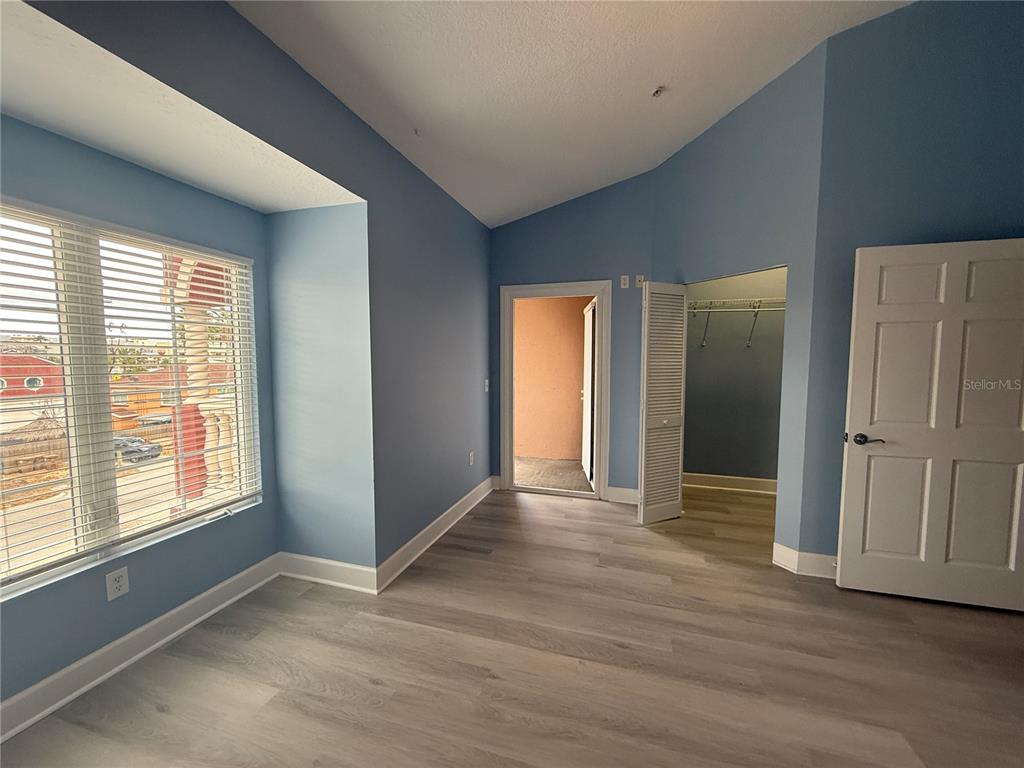 116 131st Avenue East, Unit C Madeira Beach, FL 33708 - Photo 24 of 41 an empty room with wooden floor and windows