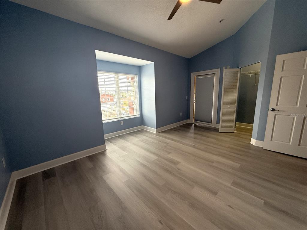 116 131st Avenue East, Unit C Madeira Beach, FL 33708 - Photo 25 of 41 an empty room with wooden floor and a window