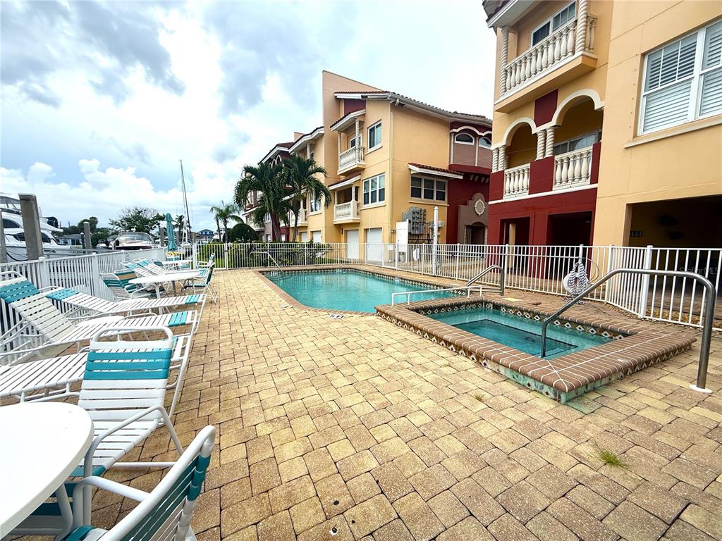 116 131st Avenue East, Unit C Madeira Beach, FL 33708 - Photo 34 of 41 a front view of a house with swimming pool