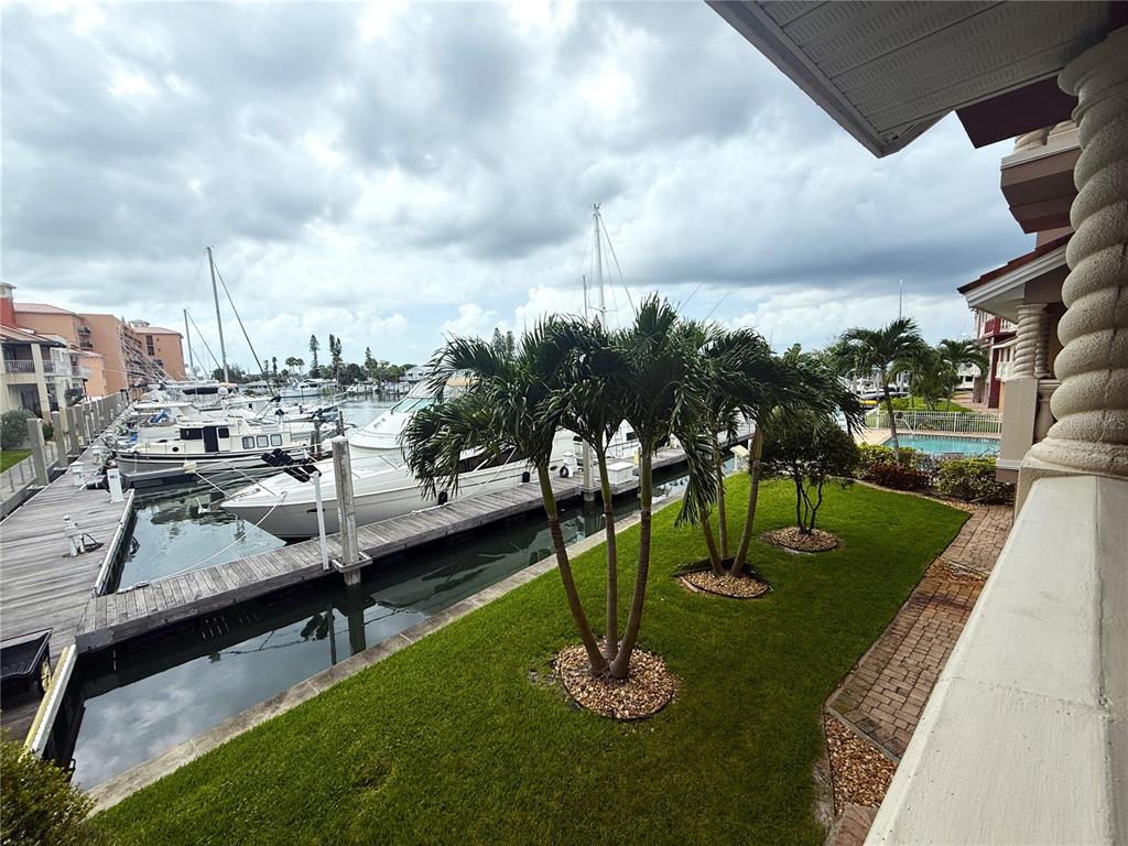 116 131st Avenue East, Unit C Madeira Beach, FL 33708 - Photo 36 of 41 a view of a swimming pool with a table and chairs