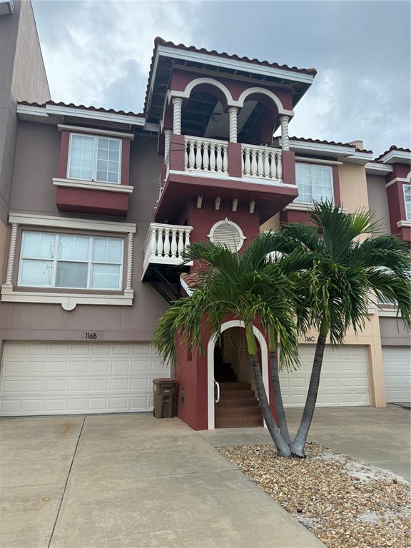 116 131st Avenue East, Unit C Madeira Beach, FL 33708 - Photo 37 of 41 a front view of a house with garden