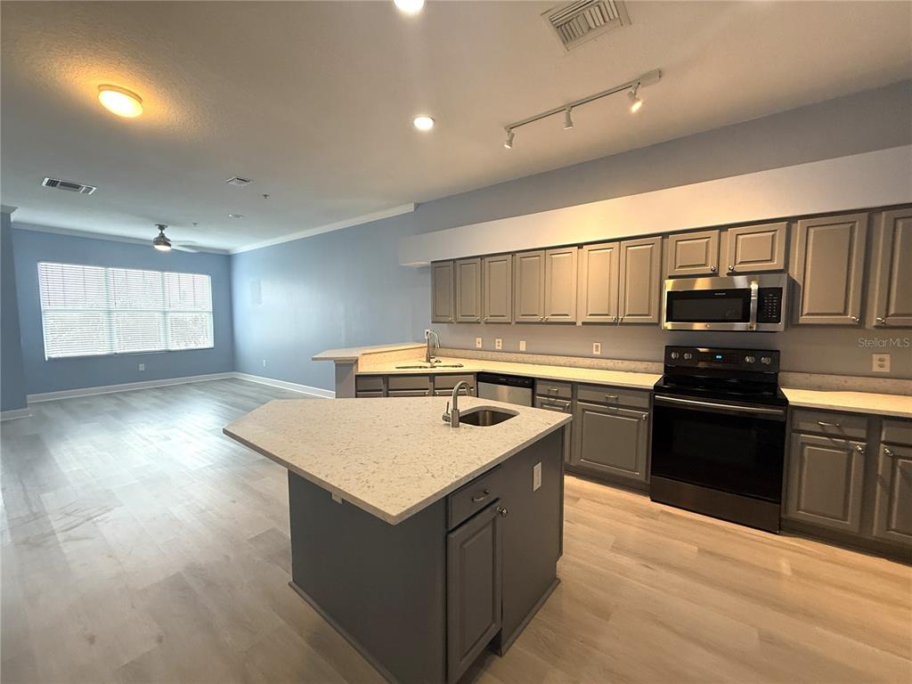 116 131st Avenue East, Unit C Madeira Beach, FL 33708 - Photo 6 of 41 a kitchen with a sink appliances and cabinets
