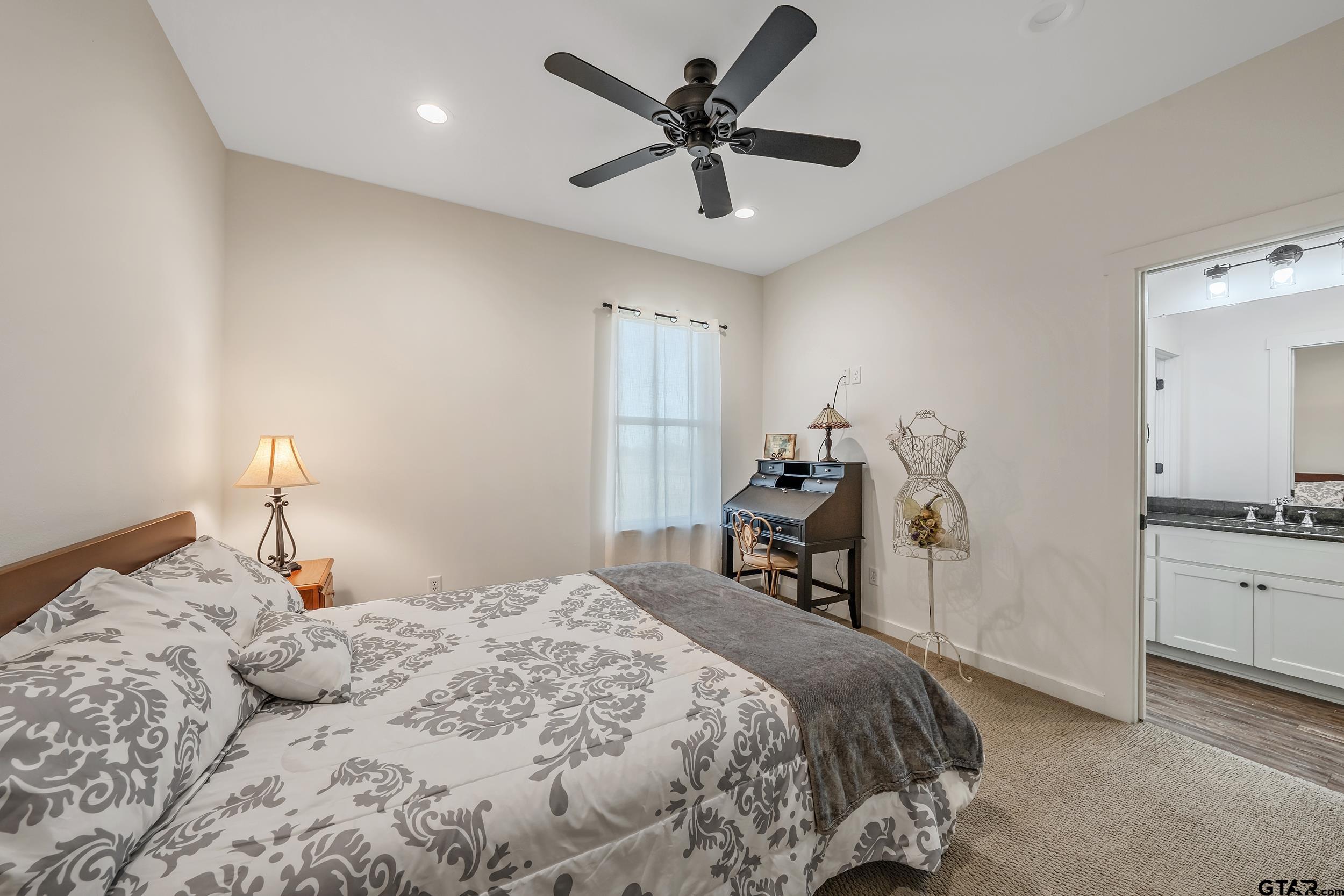 223 Riata Road Bullard, TX 75757 - Photo 21 of 45 a bedroom with a bed and a chandelier