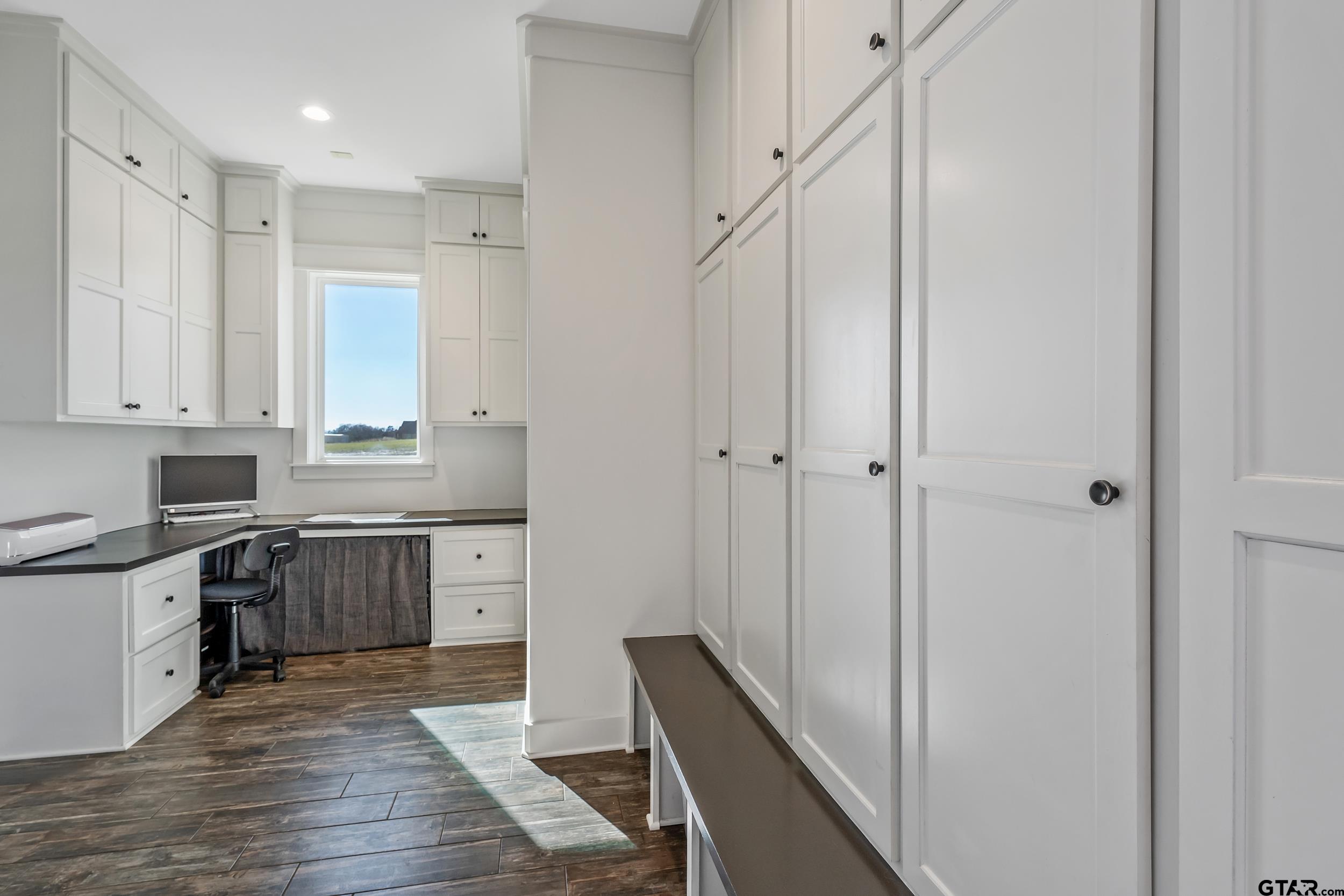 223 Riata Road Bullard, TX 75757 - Photo 27 of 45 a kitchen with cabinets appliances and a wooden floor
