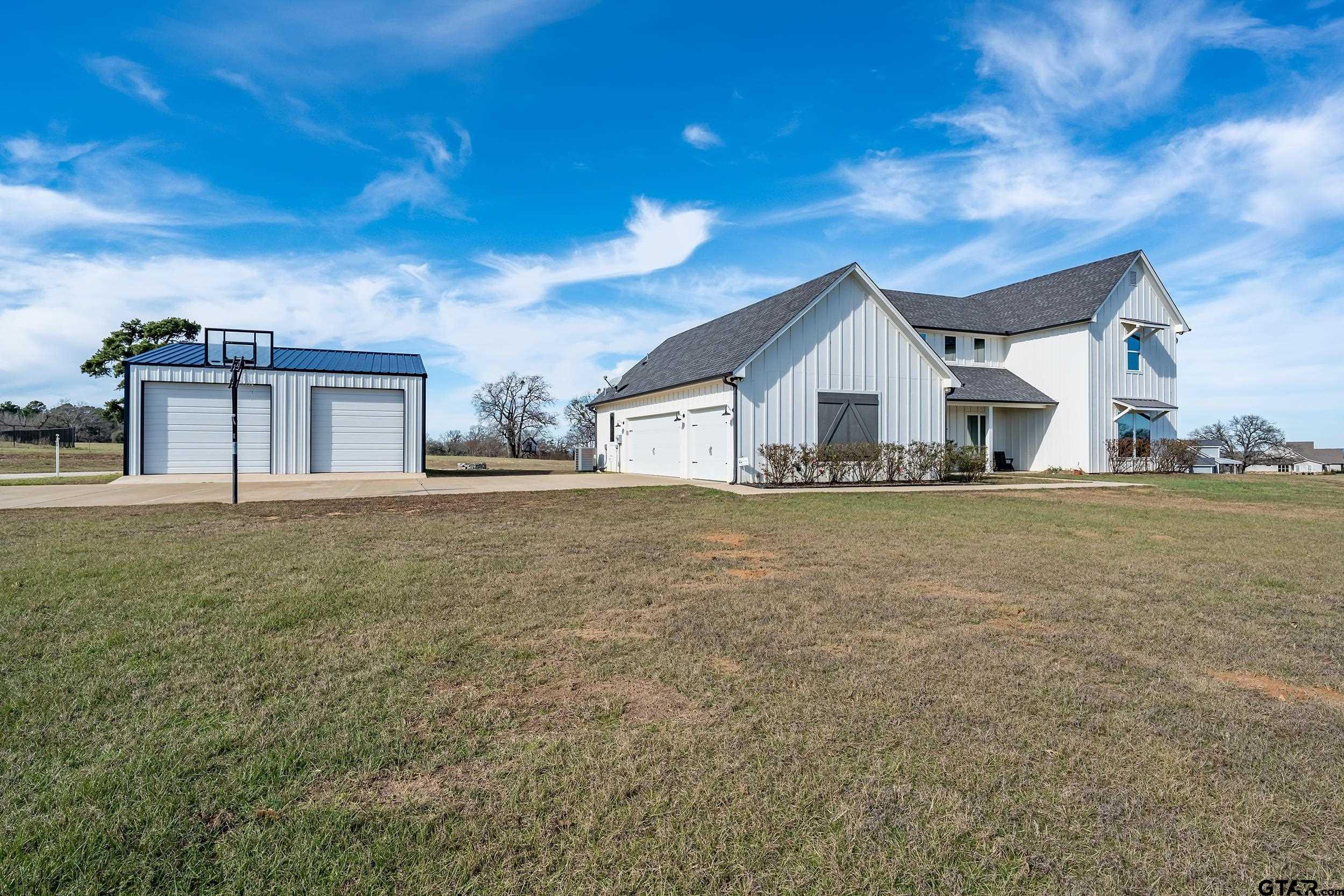 223 Riata Road Bullard, TX 75757 - Photo 44 of 45 a front view of house with yard and trees in the background