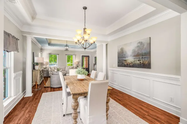 a view of a house with a yard and a large tree