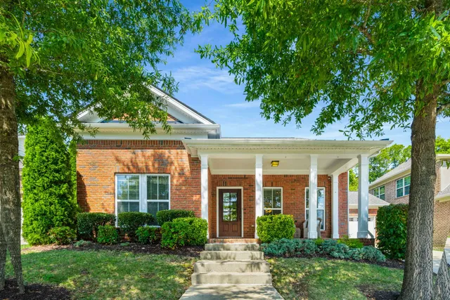 front view of a house with a tree