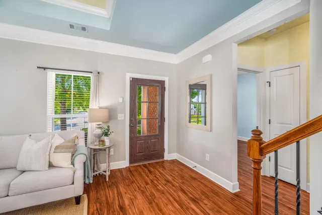a living room with furniture and a chandelier