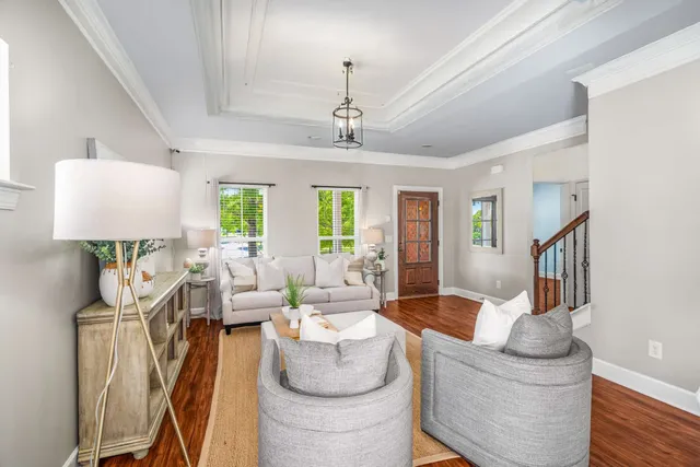a dining room with furniture a chandelier and wooden floor
