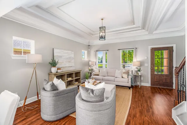 a kitchen with stainless steel appliances granite countertop a refrigerator a stove top oven a sink dishwasher and wooden cabinets with wooden floor