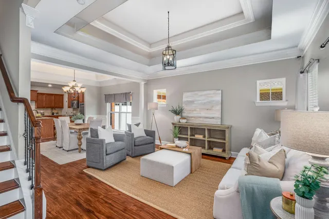 a large kitchen with stainless steel appliances granite countertop a sink dishwasher a stove a dining table and chairs with wooden floor