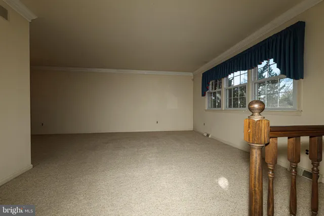 a view of a room with a floor to ceiling window and chandelier