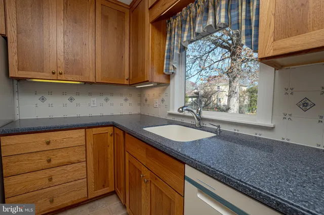 a kitchen with granite countertop stainless steel appliances sink and cabinets