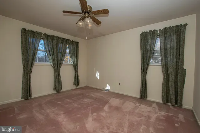 an empty room with a view of a kitchen