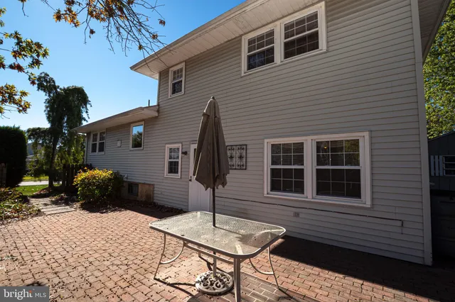 a view of a patio with a table and chairs next to a yard