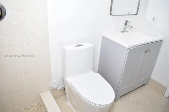 a bathroom with a sink a toilet and mirror
