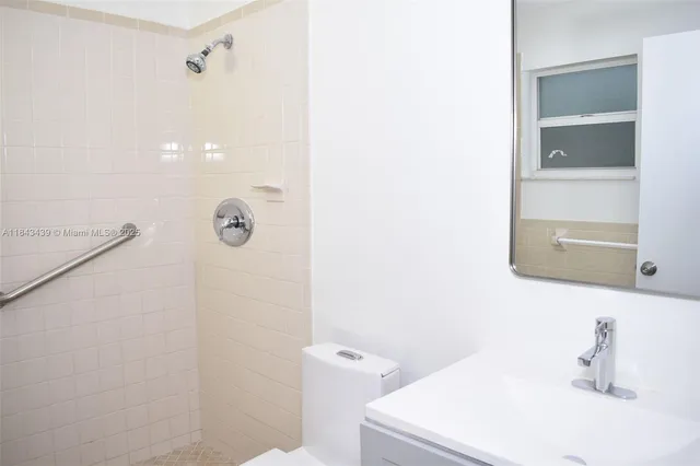 a bathroom with a white toilet and a sink