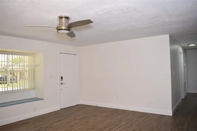 a view of a room with wooden floor closet and windows