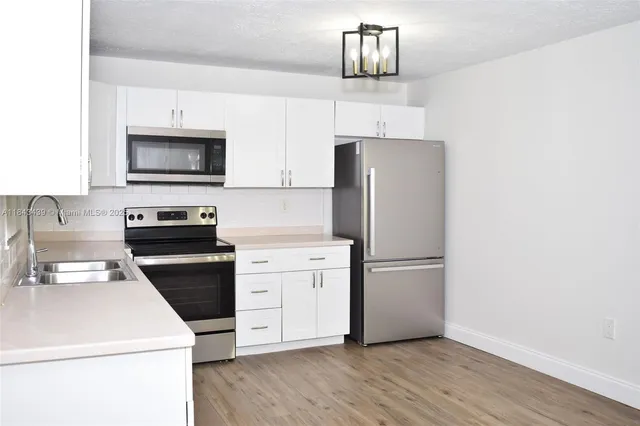 a kitchen with a refrigerator stove and microwave