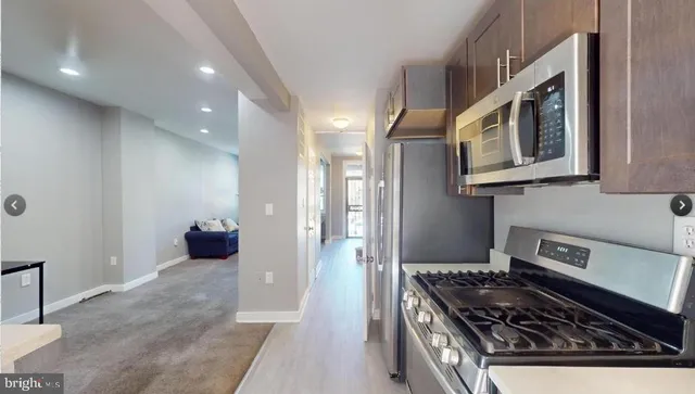 a kitchen with granite countertop a stove and a sink