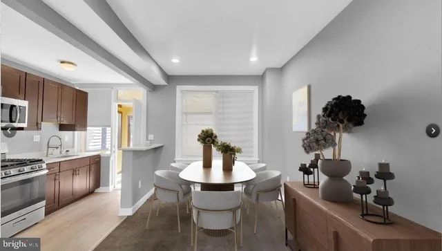 a kitchen with a table and chairs in it