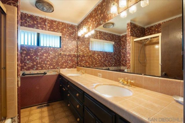a bathroom with a sink double vanity and a mirror