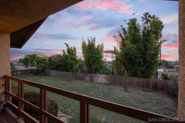 a view of a balcony with chair and potted plants