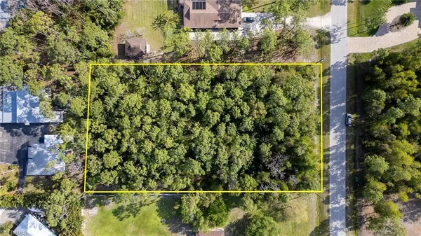 an aerial view of a residential houses with yard