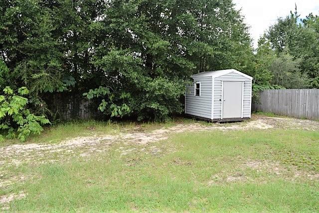 123 Oak Terrace Drive Crestview, FL 32539 - Photo 20 of 21 a view of a tiny house with a yard and large trees