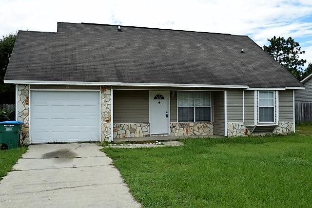 123 Oak Terrace Drive Crestview, FL 32539 - Photo 2 of 21 a front view of a house with a yard